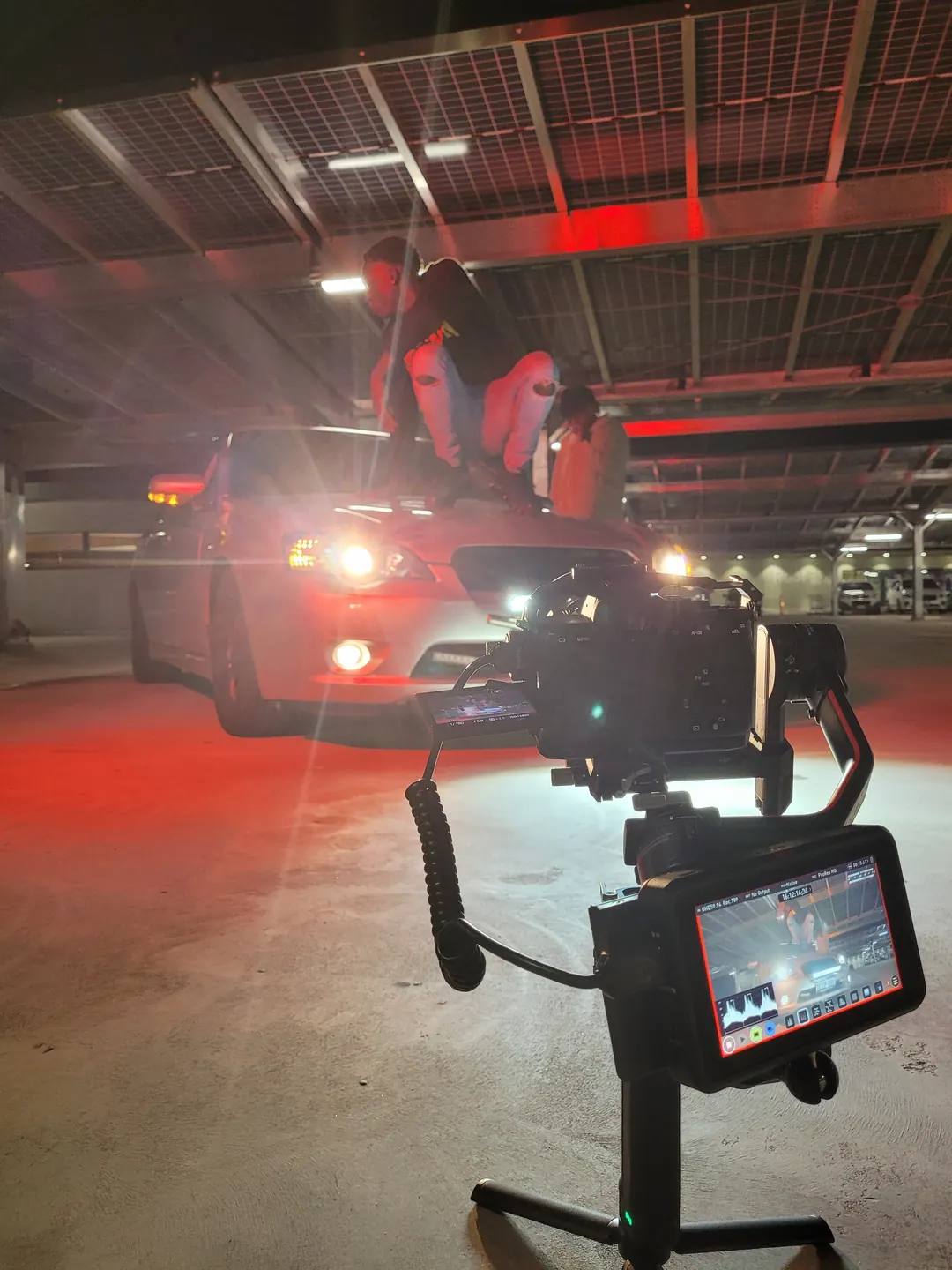 Filming on a car bonnet in a car park