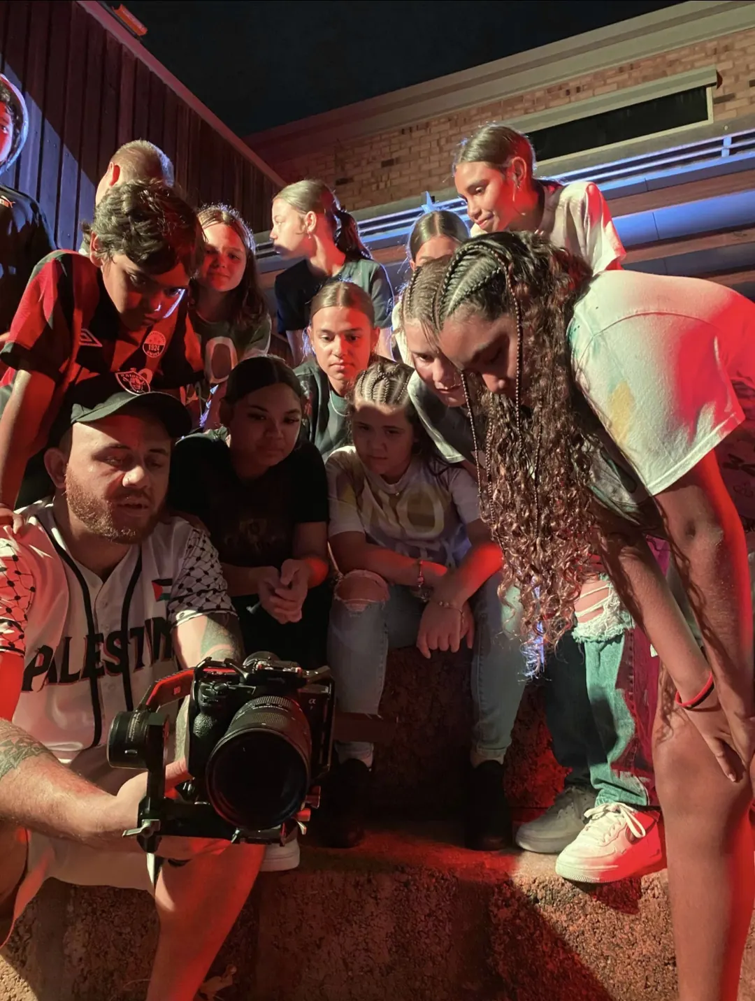 Reviewing a take with the cast on location